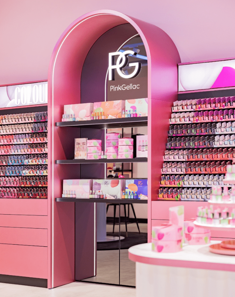 Pink-themed store interior completely filled with nail polish products, including shelves with bottles and displayed packaging under an arched entrance with the Pink Gellac logo.