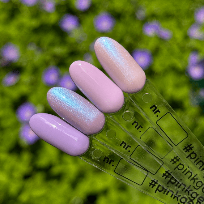 Four nail samples in different shades of pink and lilac with a gloss effect, against a green background with purple flowers.
