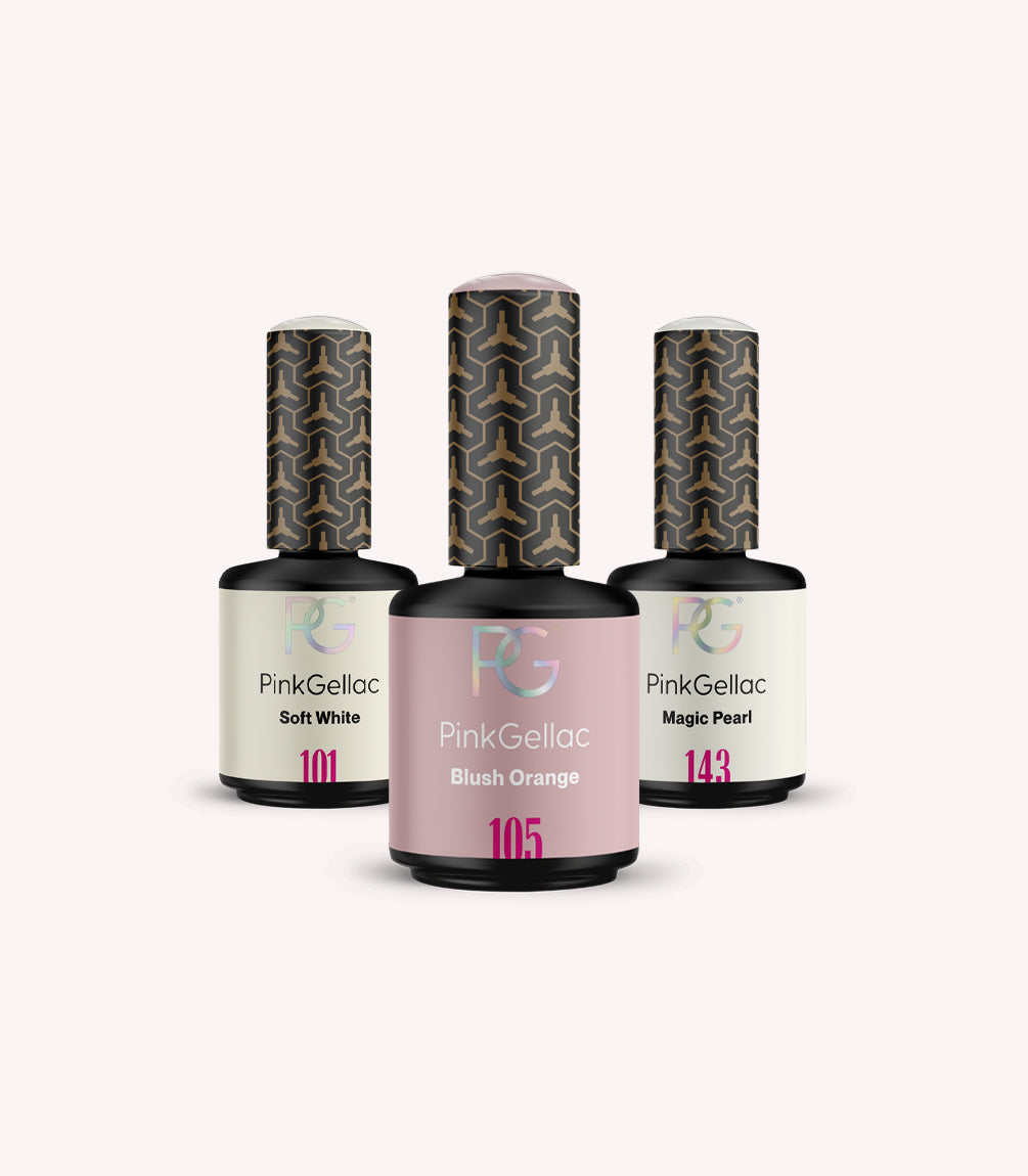 Three bottles of Pink Gellac nail polish with the colors Soft White, Blush Orange and Magic Pearl on a light background.