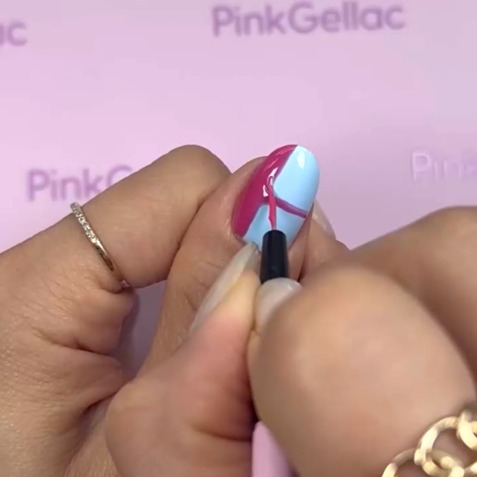 A hand with a ring on the finger paints a pink line on a nail with blue nail polish against a pink background with the logo "Pink Gellac".