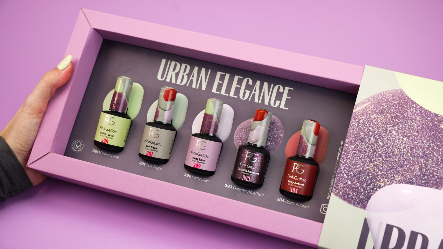 A hand holds an open box with five bottles of Pink Gellac nail polish in different colors, with the text "Urban Elegance" in the lid, against a purple background.