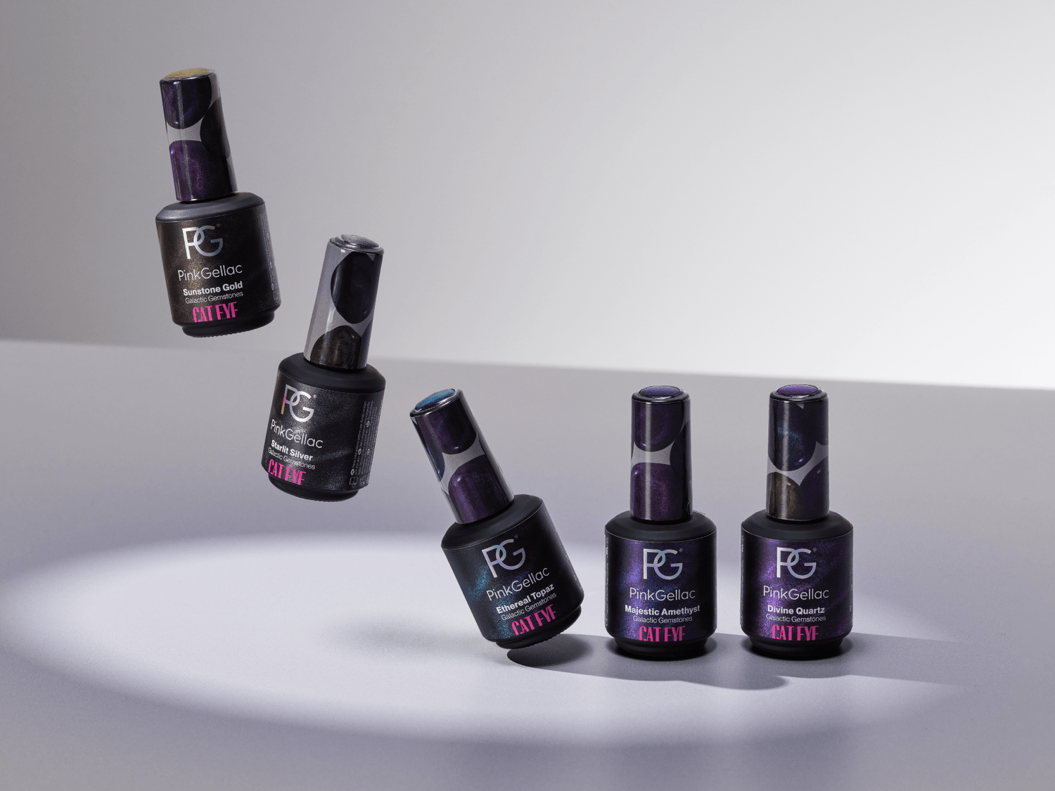 Five bottles of Pink Gellac nail polish, varying in colors, floating and standing against a gray background.