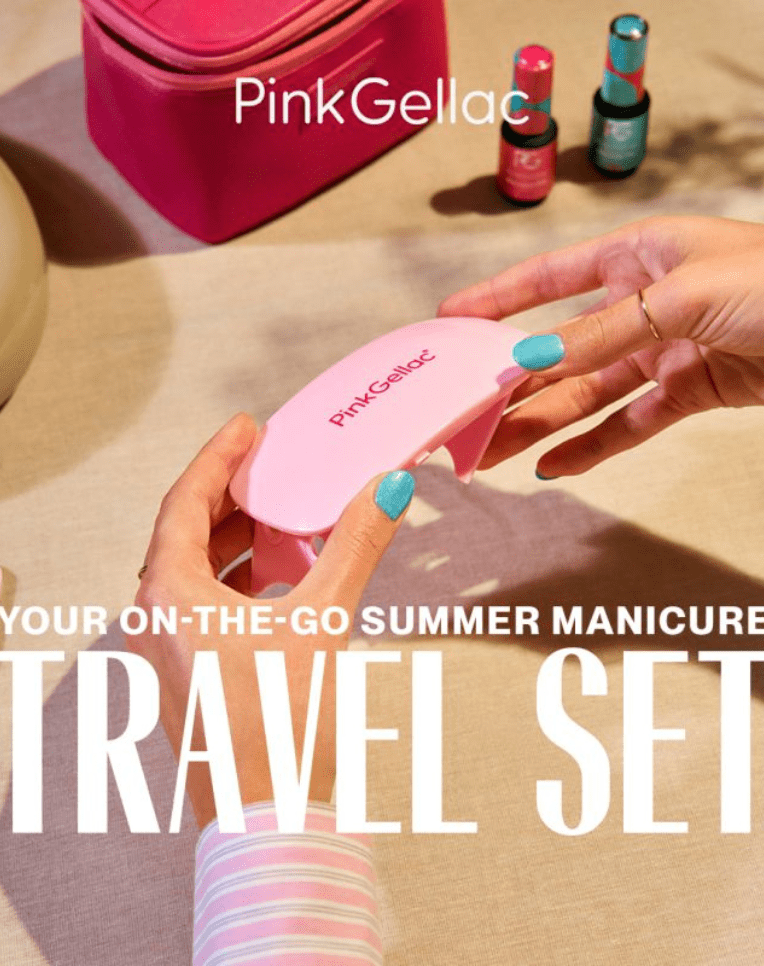 Person with blue painted nails holds a pink Pink Gellac UV lamp, with a pink bag and bottles of nail polish in the background, with the text "Your On-The-Go Summer Manicure Travel Set".