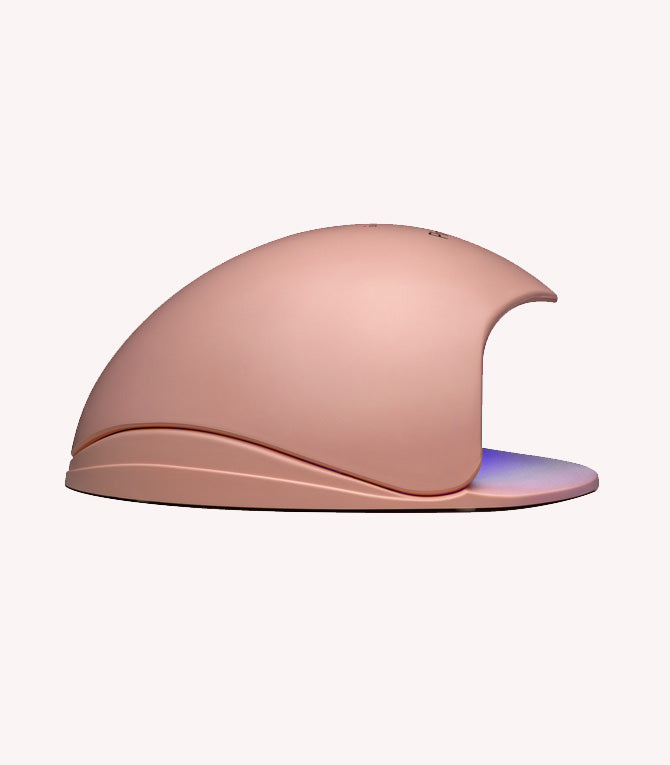 A beige UV lamp for nails with a curved design and an opening for hands.