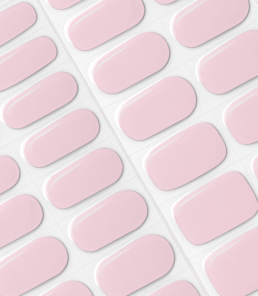 Pink oval nail stickers arranged in rows on a sheet.