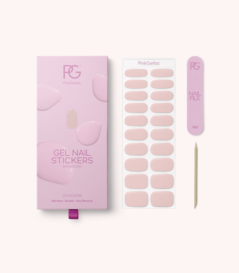 Pink packaging with gel nail stickers, next to a sheet with pink stickers, a pink cardboard nail file, and a wooden cuticle pusher.