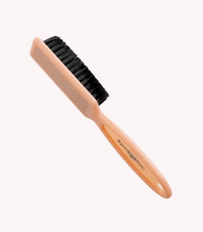 Orange comb with black brush part and a handle that says "#pinkleilac".