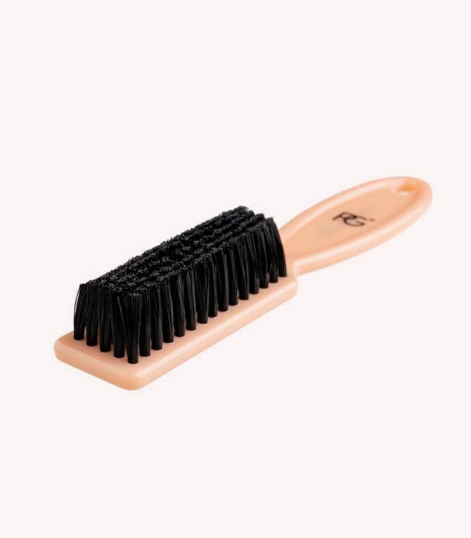 Orange shoe brush with a handle and black brushes.