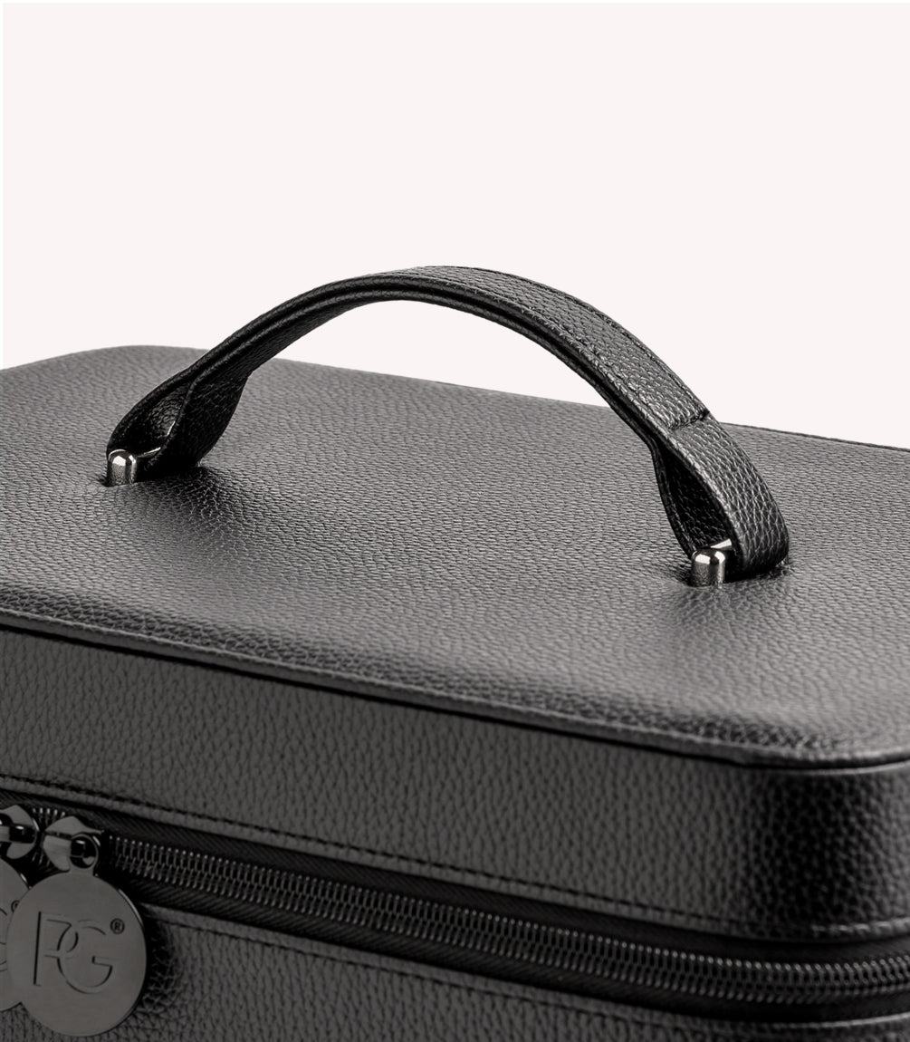 Black leather case with handle and zipper, partially exposed.