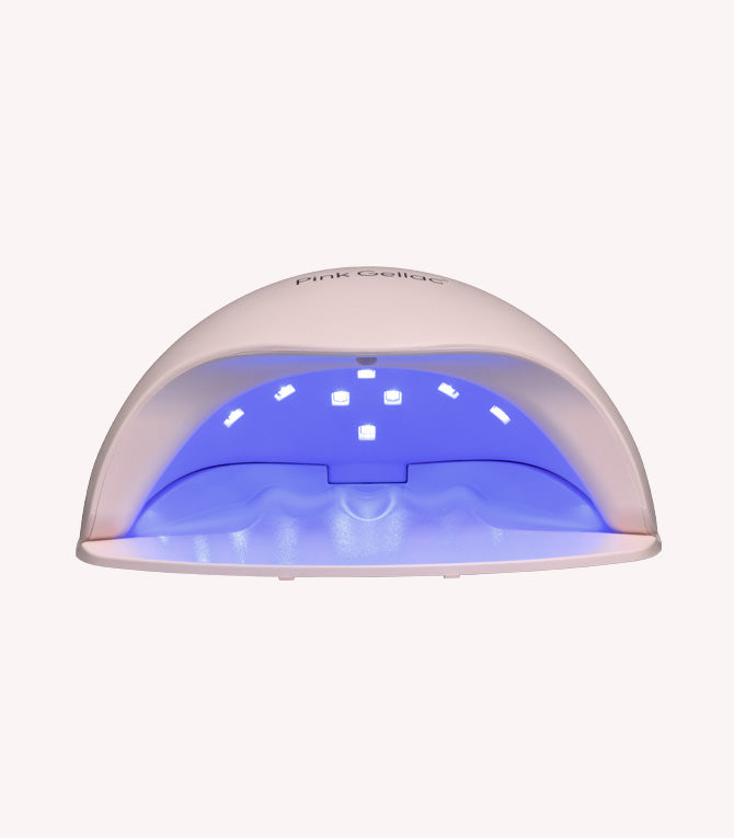 A white UV lamp for nails with blue light on the inside.