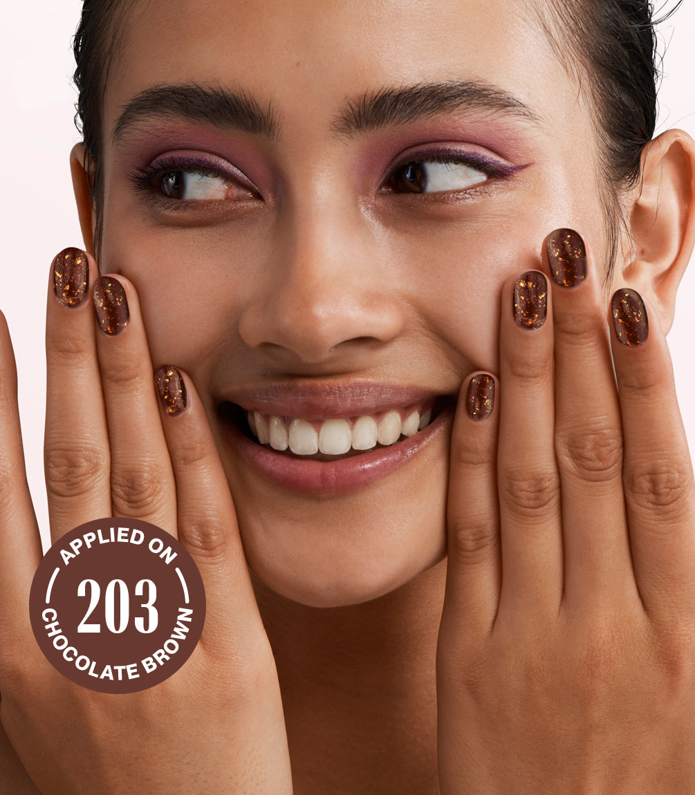 One person smiles and holds both hands with brown nail polish to her cheeks, with a speech bubble that mentions "APPLIED ON 203 CHOCOLATE BROWN".
