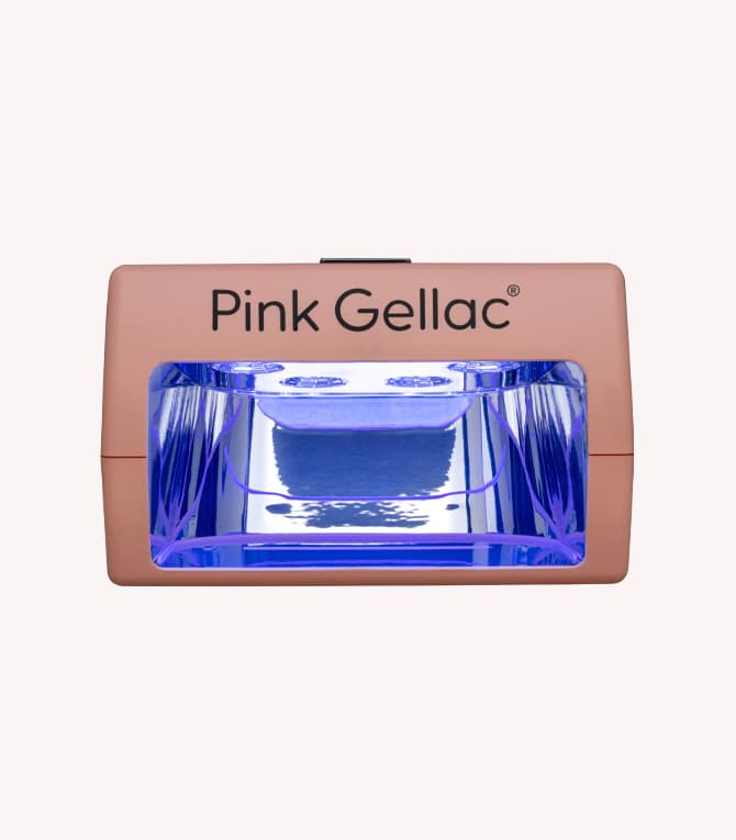 Gel polish lamp with a pink exterior and blue light on the inside of the Pink Gellac brand.