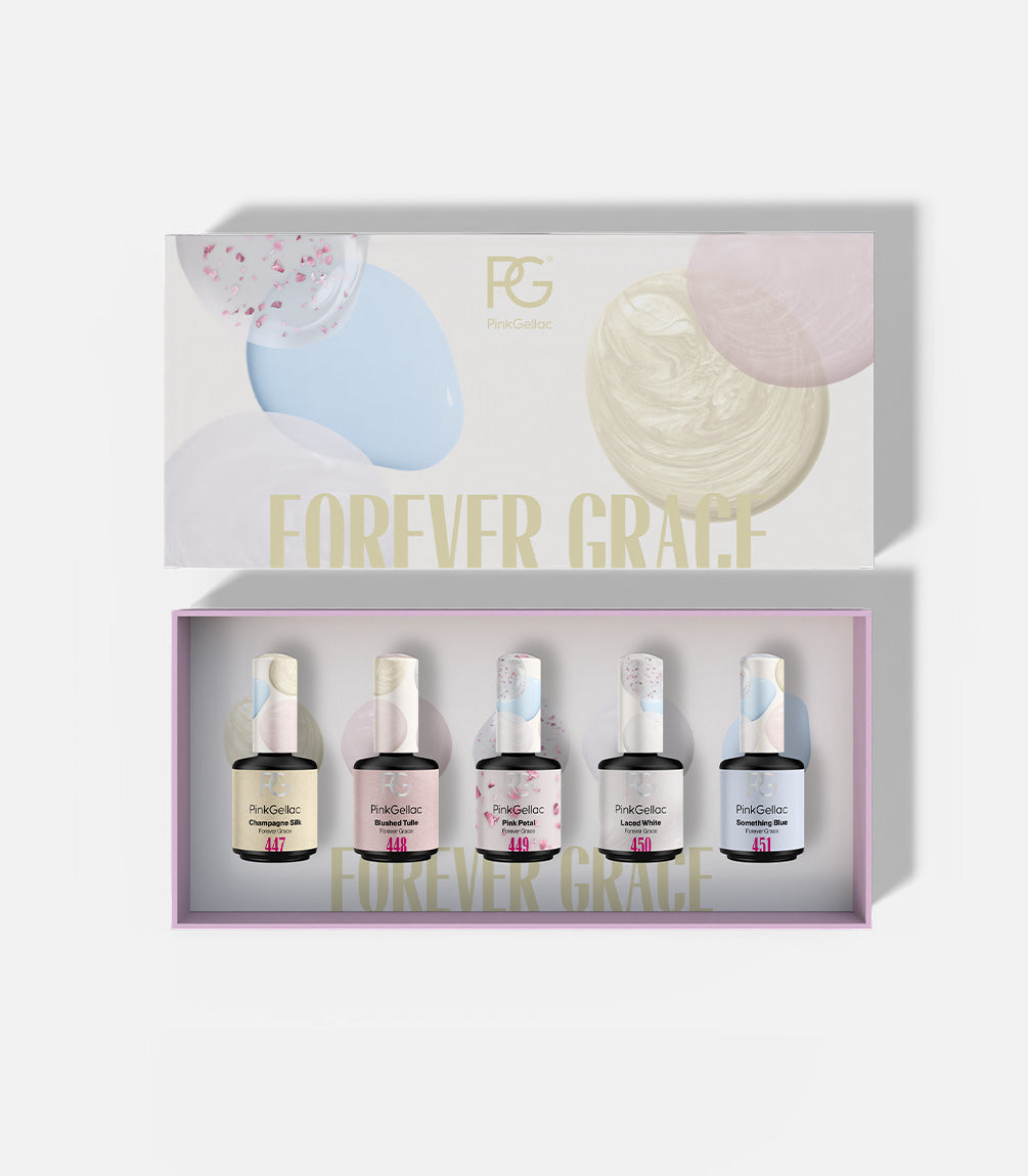 A box with a lid in the background with the text "Forever Grace" and in it four bottles of Pink Gellac nail polish in different colors.