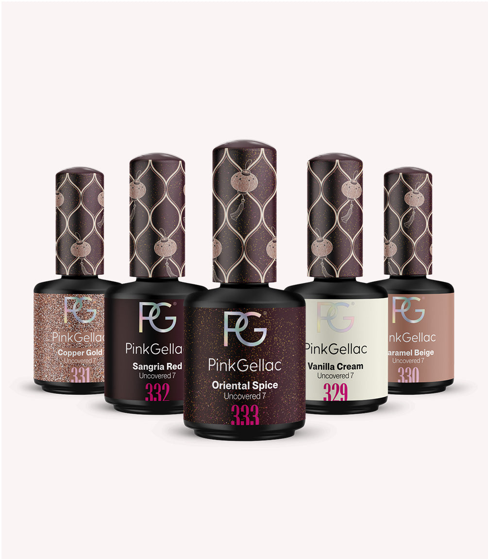 Five bottles of Pink Gellac nail polish in different colors: copper gold, sangria red, oriental spices, vanilla cream and caramel beige, with decorative caps.