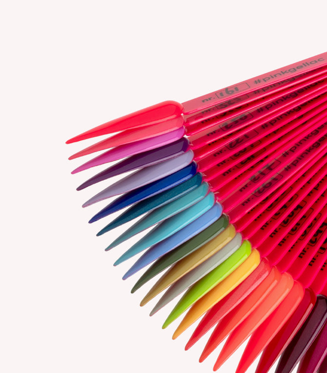 A range of nail polish colors in different shades, arranged on plastic color samples.