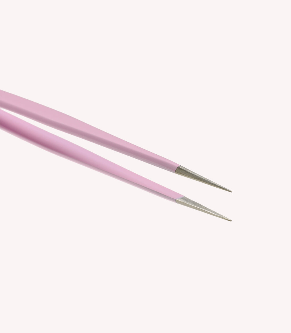 Two pink tweezers with sharp metal tips against a white background.