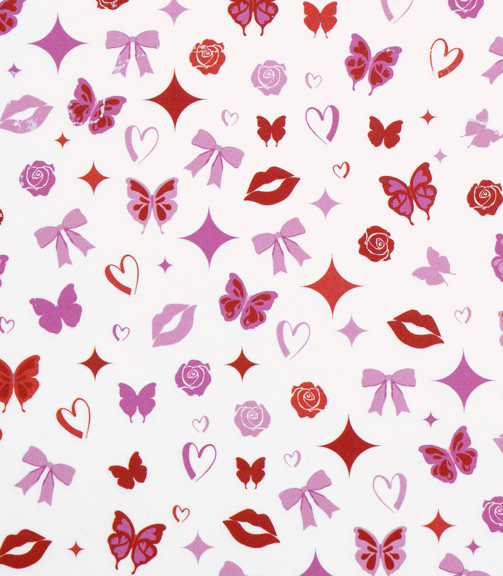 A pattern of various pink and red symbols, including butterflies, lip prints, stars, roses, bows and hearts on a white background.