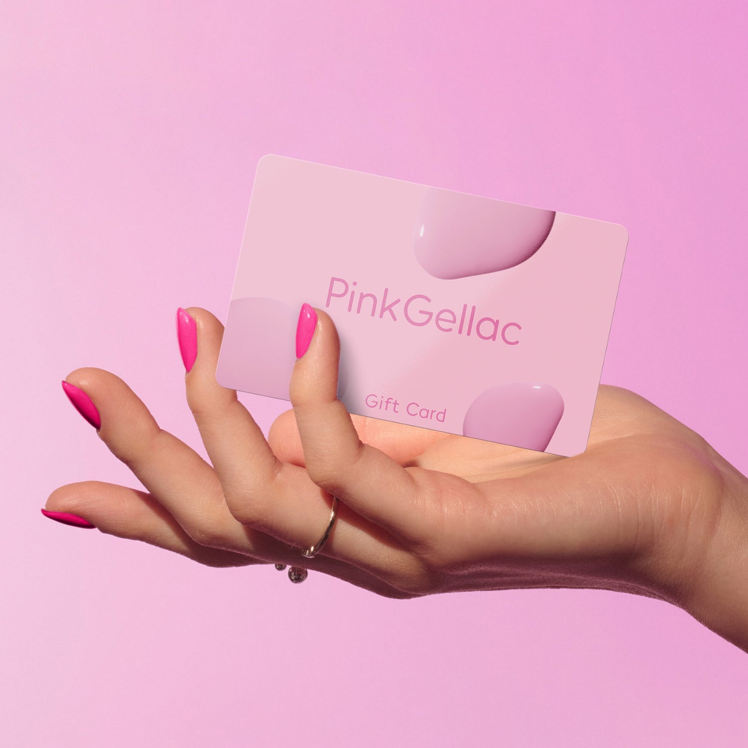 A hand with pink nails holds a PinkGellac gift card against a pink background.