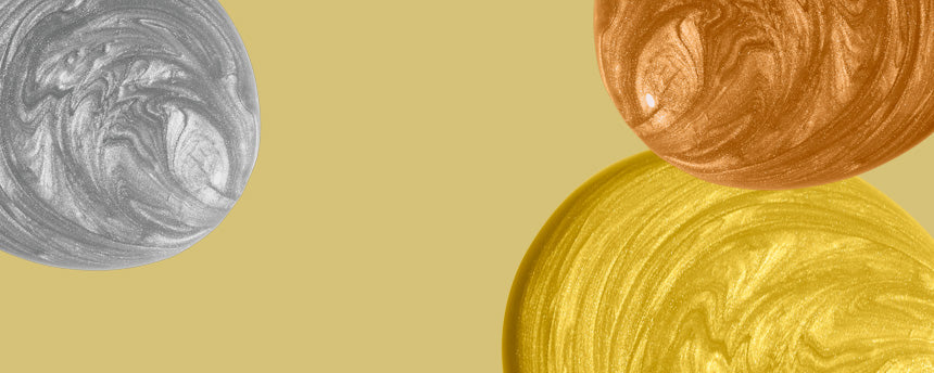 Image with abstract, marbled spots in silver, copper and gold on a light brown background.