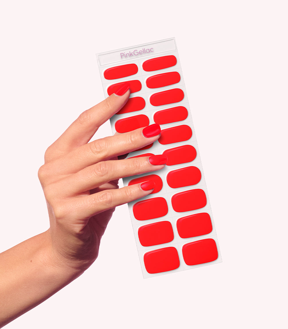 Hand wearing Pink Gellac 057 Bisou Red gel nail stickers.