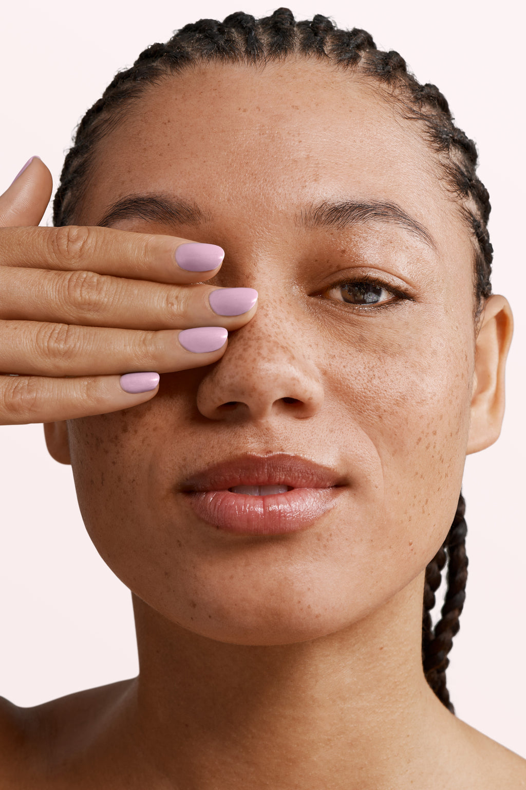 Close-up of a woman with Pink Gellac 131 Baby Lila manicured nails near her face.