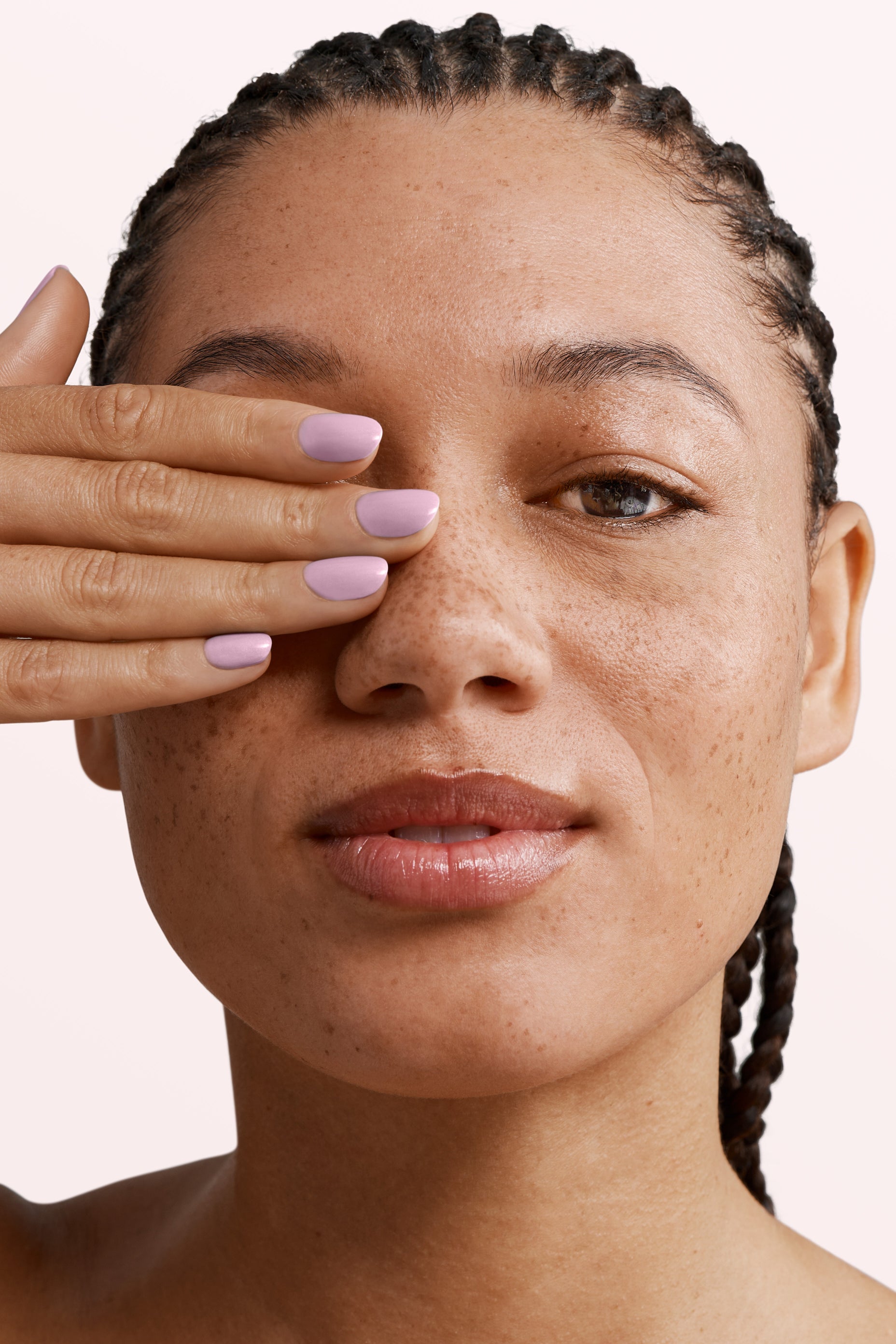 Close-up of a woman with Pink Gellac 131 Baby Lila manicured nails near her face.