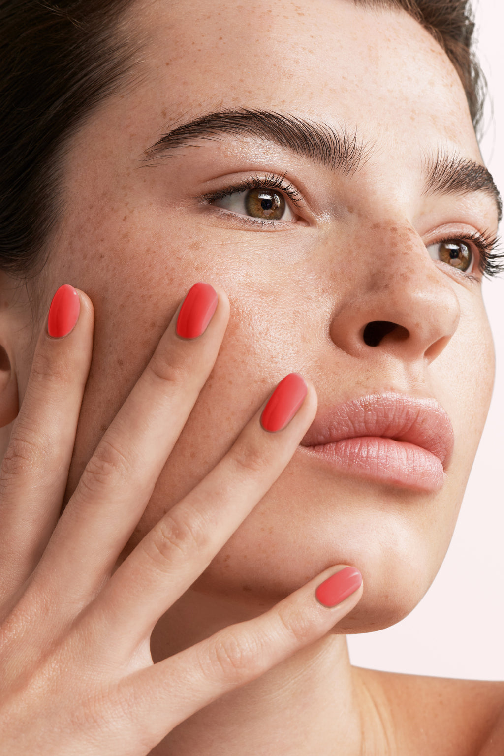 Close-up of a woman with Pink Gellac 133 Fuchsia Red manicured nails near her face.