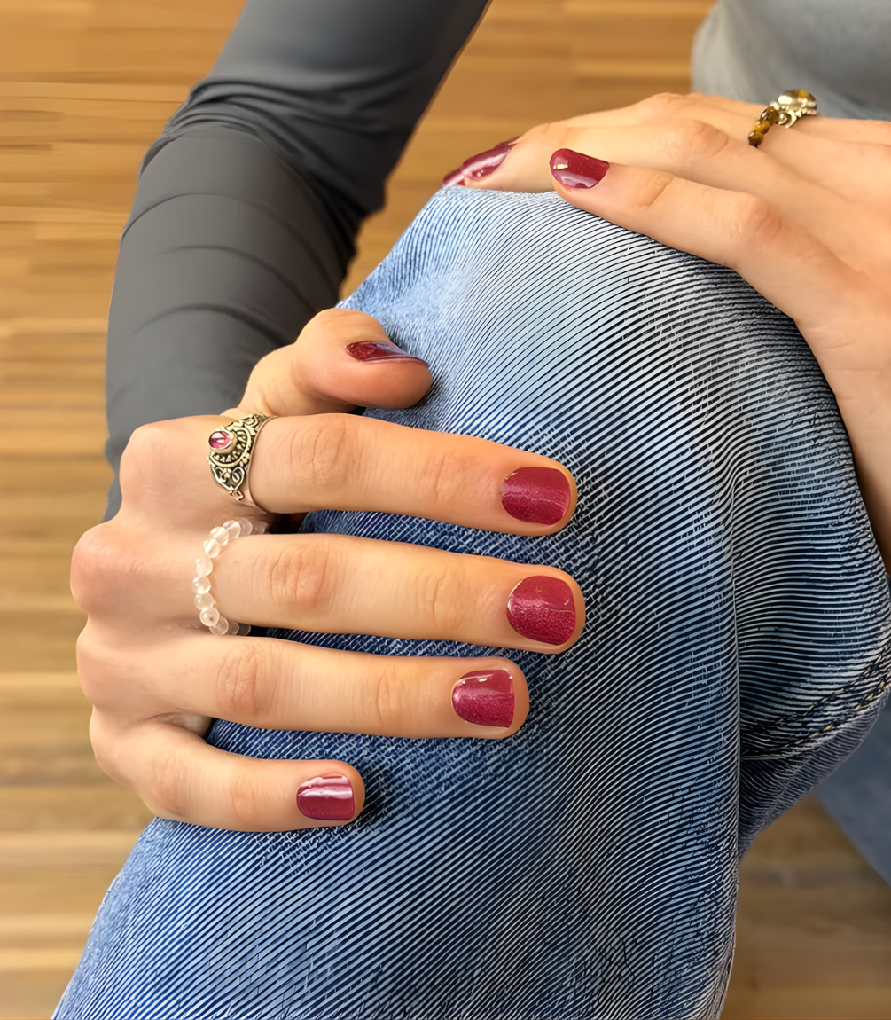 Hand wearing Pink Gellac 027 Cat Eye Flamenco Red gel nail stickers.