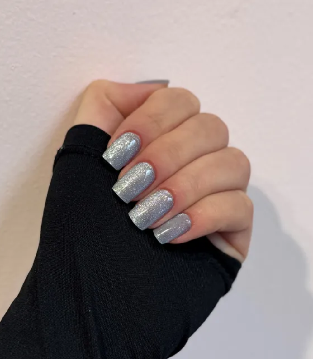 Hand wearing Pink Gellac 026 Cat Eye Misty Blue gel nail stickers.