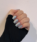 Hand wearing Pink Gellac 026 Cat Eye Misty Blue gel nail stickers.