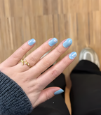 Hand wearing Pink Gellac 009 Holographic Blue gel nail stickers.