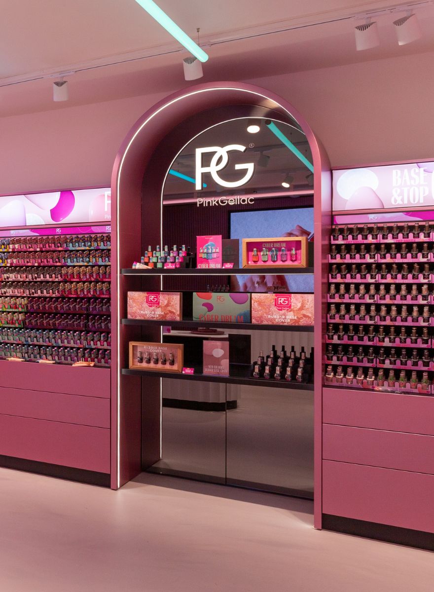Shop display with various nail polish products from Pink Gellac in a pink and modern interior.