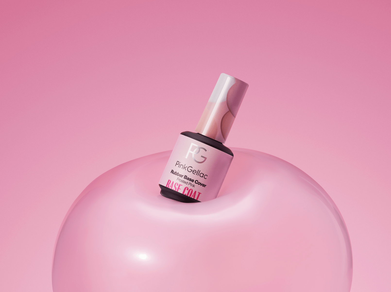 A bottle of Pink Gellac Rubber Base Cover in Frosted Pink rests on a shiny, pink background with a pink background.