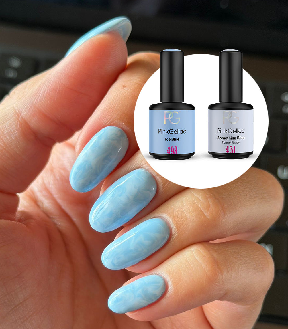 Hand with a marble manicure created with the Pink Gellac Ice Blue Marble set.