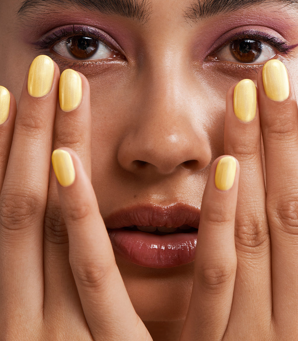 Manicured nails painted with Pink Gellac 487 Yummy Yellow gel polish.