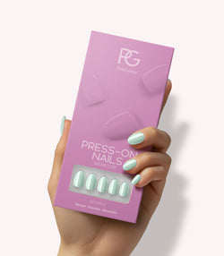 Hand holding Pink Gellac 488 Melted Mint press-on nails in their packaging.