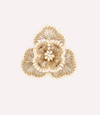 Decorative golden rose ornament on a light background.