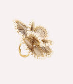 Decorative golden floral ornament on a light background.