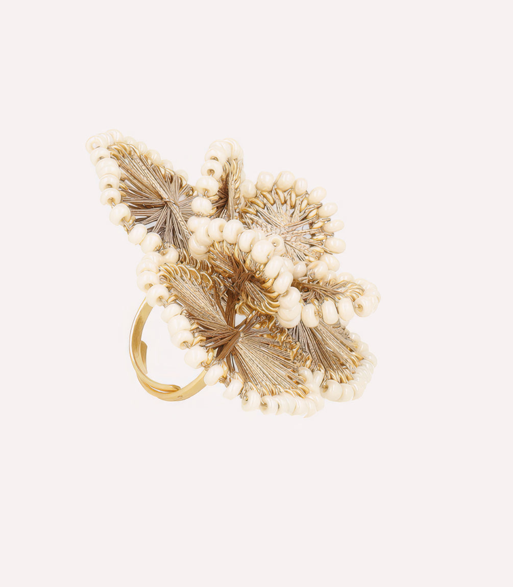 Decorative golden floral ornament on a light background.