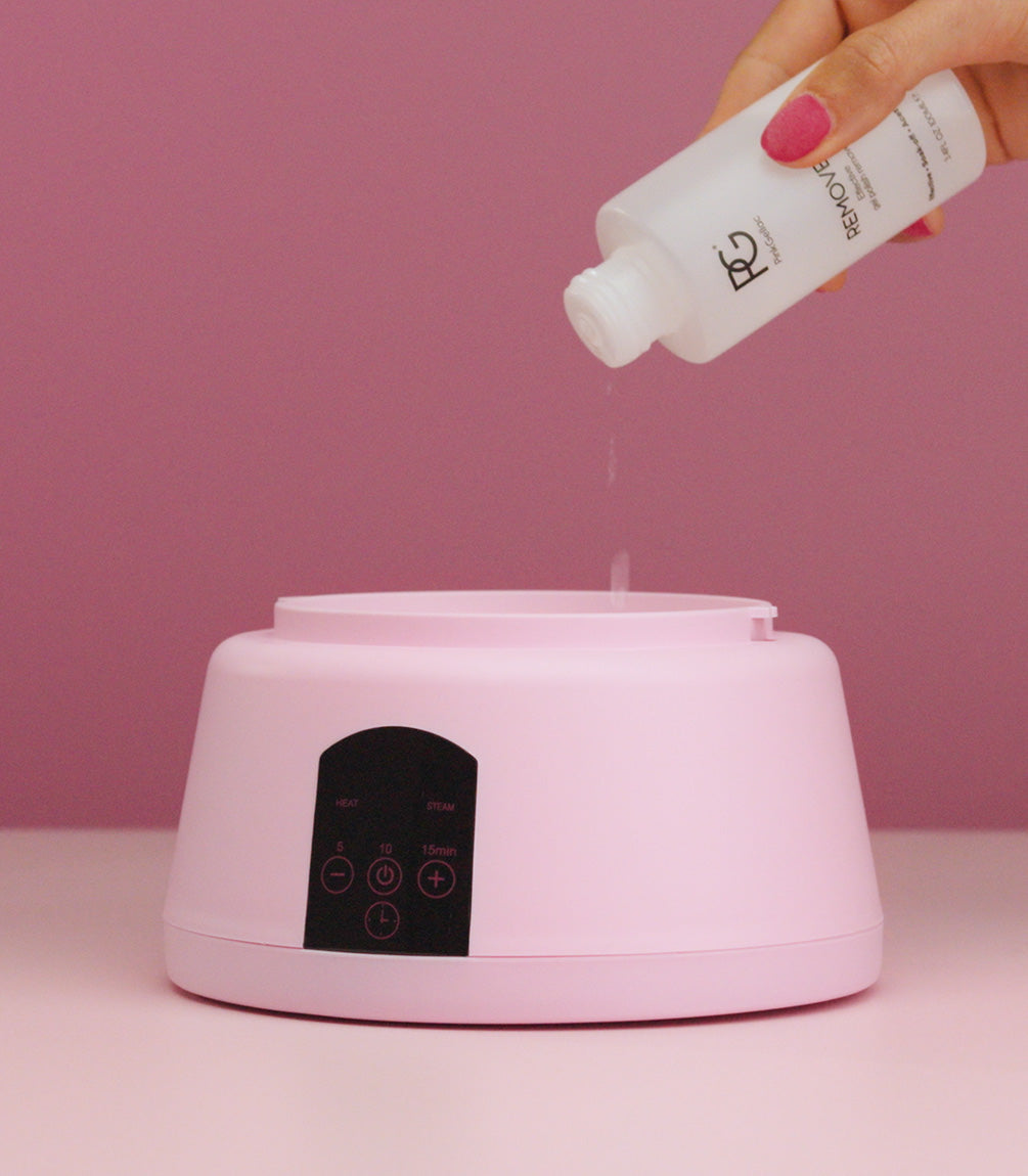 Pouring gel remover into the Pink Gellac steam removal device.