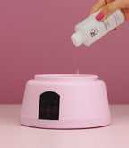 Pouring gel remover into the Pink Gellac steam removal device.