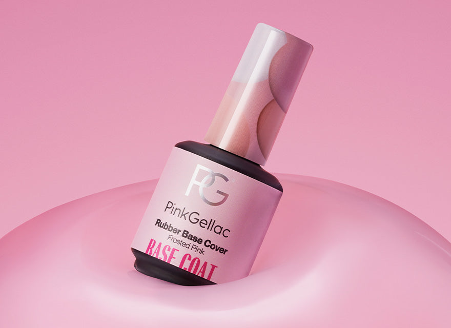 A bottle of Pink Gellac Rubber Base Cover in the color Frosted Pink lies diagonally on a pink background.