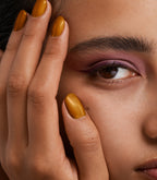 Close-up of a woman with Pink Gellac 417 Beloved Bronze manicured nails near her face.
