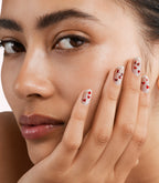 Close-up of a woman with Pink Gellac 440 Cupid's Glitter manicured nails near her face.