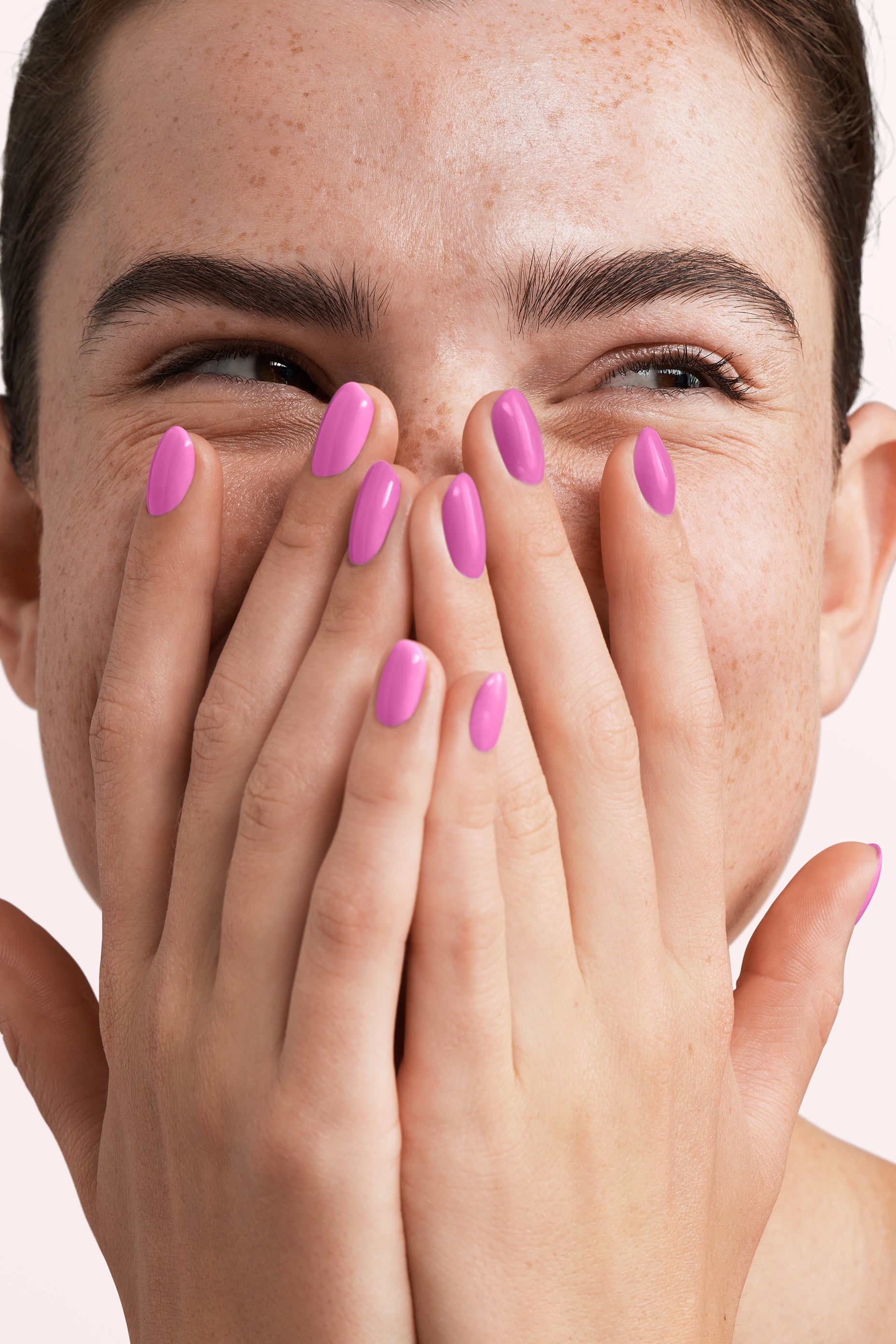 Close-up of a woman with Pink Gellac 326 Chaotic Pink manicured nails near her face.