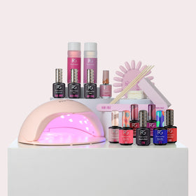 Gel nail polish set with lamp, nail polish bottles, nail file, wooden sticks and two bottles of nail cleaner.