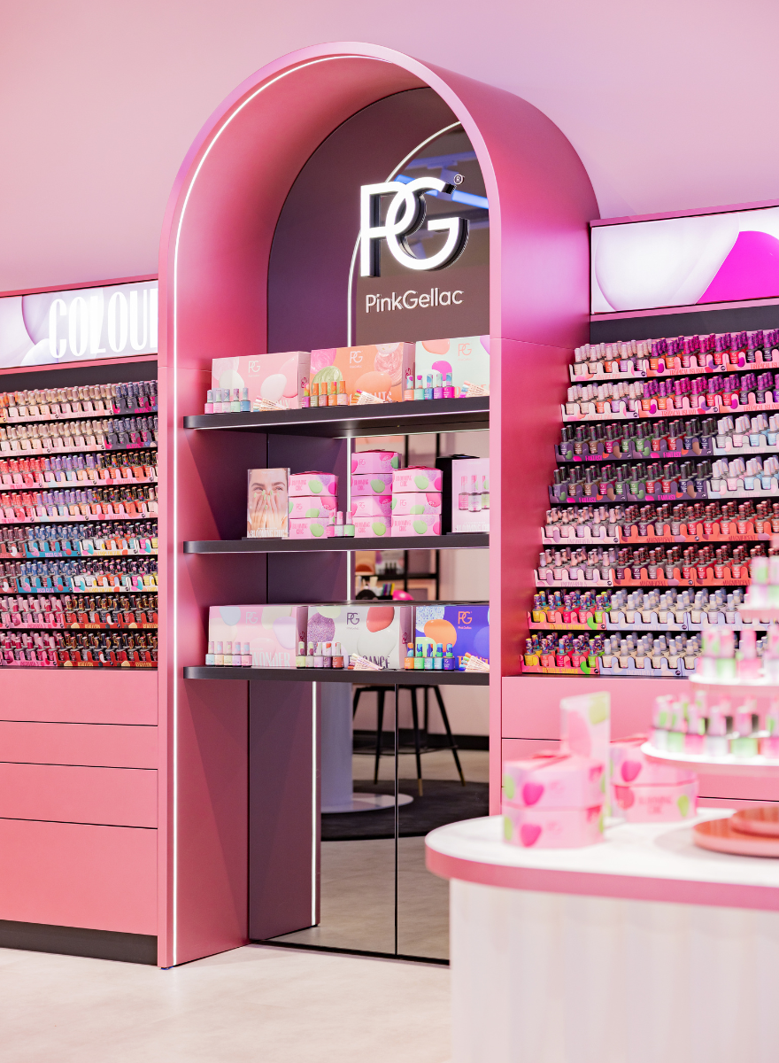 Pink shop interior with nail polish bottles and gift boxes from Pink Gellac on shelves.