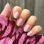 Hand with manicured nails wearing Pink Gellac 490 Bare Rose gel polish.