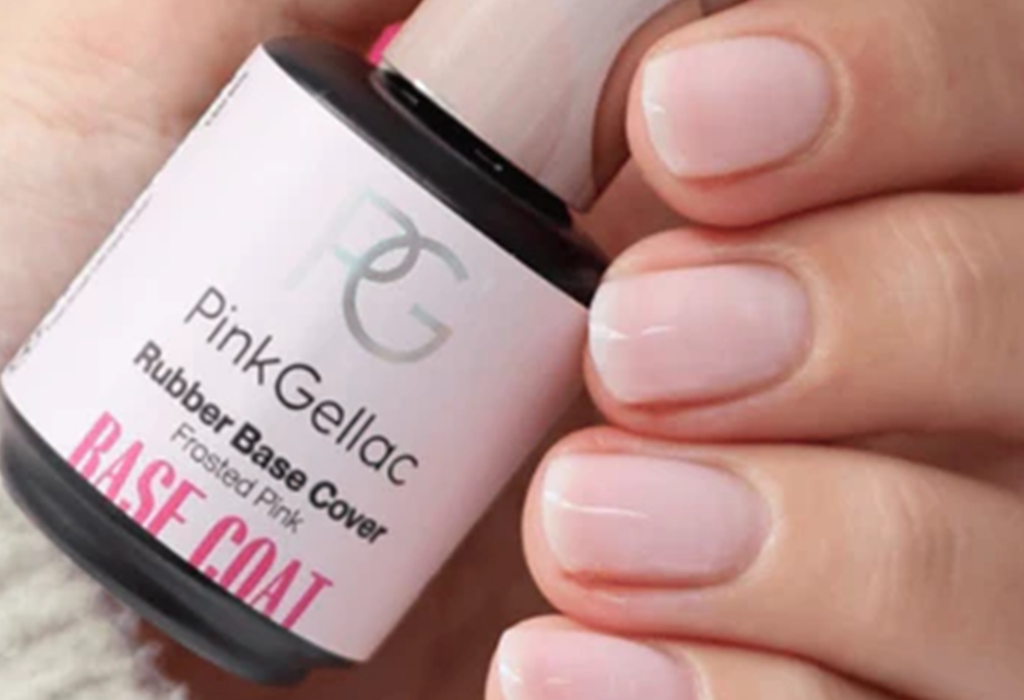 Bottle of Pink Gellac Rubber Base Cover with Frosted Pink, held by a hand with neatly painted nails.