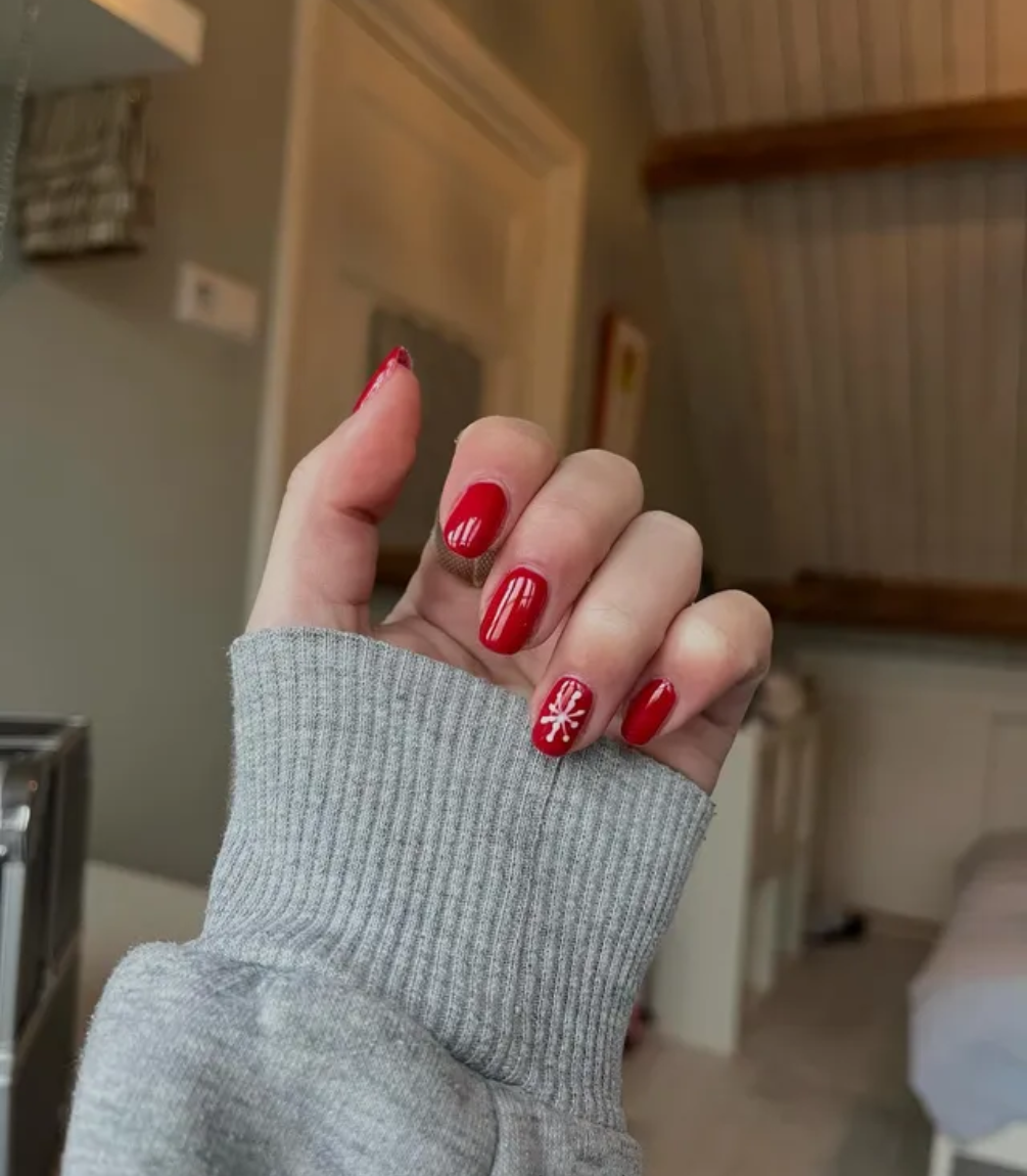Hand with red manicured nails wearing Pink Gellac 109 Lipstick Red gel polish.